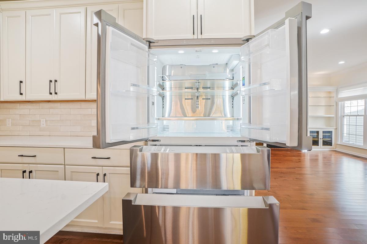 2442 Arctic Fox Way Reston, VA 20191 - Photo 23 of 58 a view of a kitchen with wooden floor and a cabinet