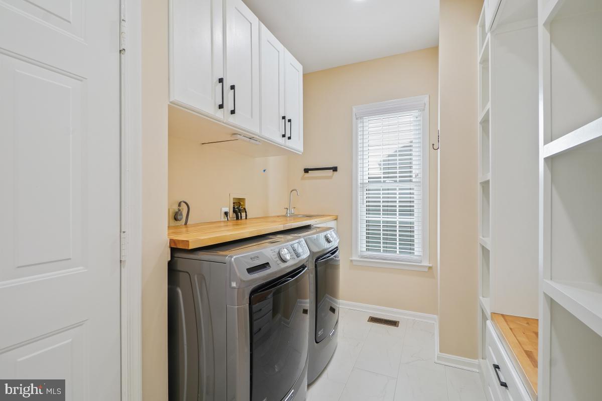 2442 Arctic Fox Way Reston, VA 20191 - Photo 24 of 58 a utility room with cabinets washer and dryer