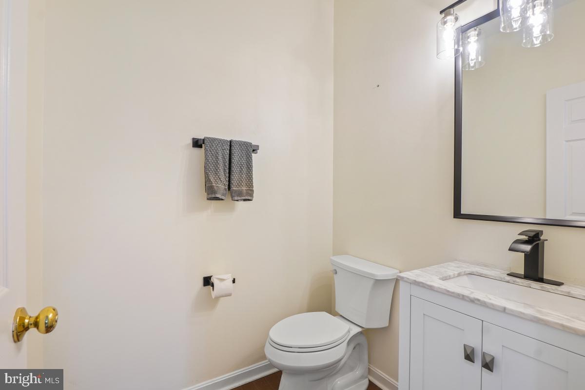 2442 Arctic Fox Way Reston, VA 20191 - Photo 25 of 58 a bathroom with a granite countertop sink vanity mirror and toilet