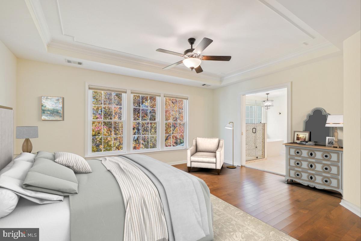 2442 Arctic Fox Way Reston, VA 20191 - Photo 27 of 58 a spacious bedroom with a bed and ceiling fan