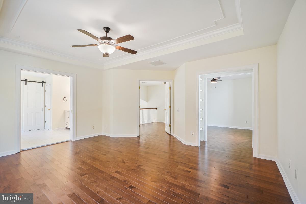 2442 Arctic Fox Way Reston, VA 20191 - Photo 30 of 58 a view of empty room with wooden floor and ceiling fan