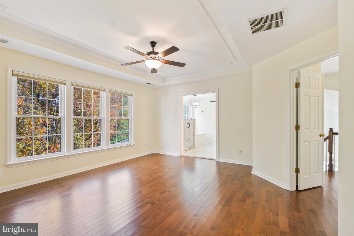 2442 Arctic Fox Way Reston, VA 20191 - Photo 31 of 58 a view of an empty room with a window and wooden floor