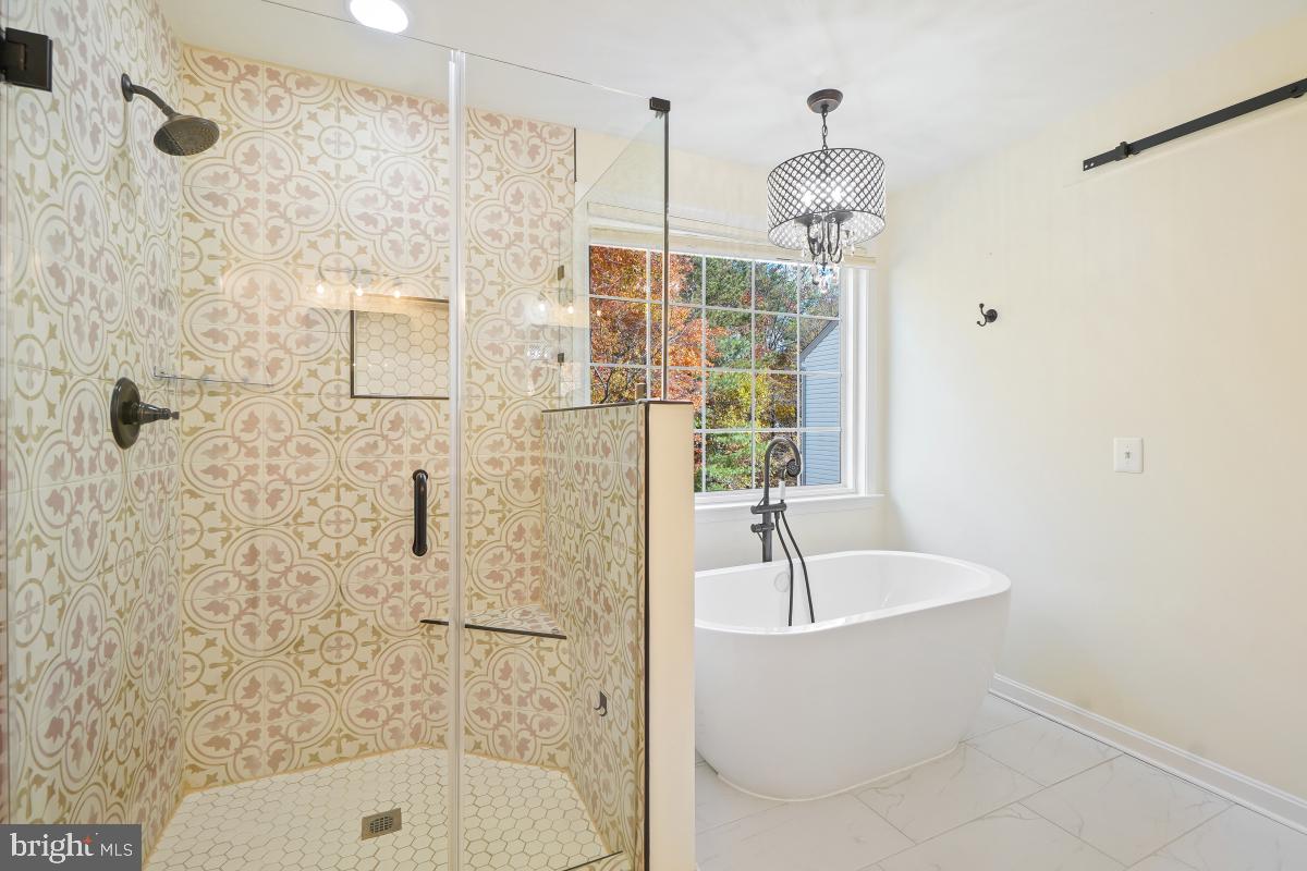2442 Arctic Fox Way Reston, VA 20191 - Photo 33 of 58 a bathroom with a sink a mirror a bathtub and shower