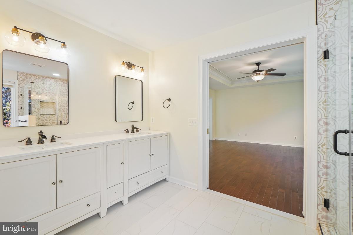 2442 Arctic Fox Way Reston, VA 20191 - Photo 34 of 58 a bathroom with a double vanity sink and mirror