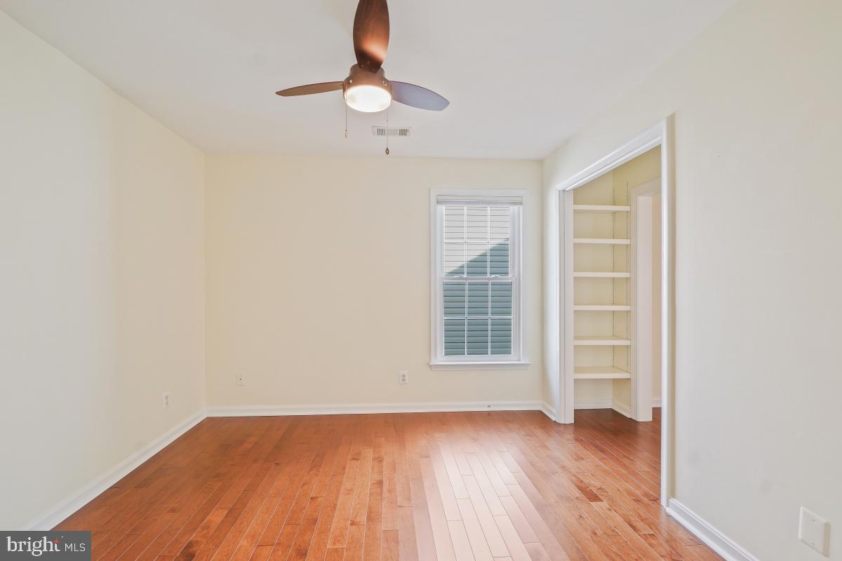 2442 Arctic Fox Way Reston, VA 20191 - Photo 36 of 58 an empty room with wooden floor fan and window