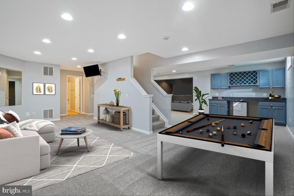 2442 Arctic Fox Way Reston, VA 20191 - Photo 40 of 58 a living room with furniture and a flat screen tv