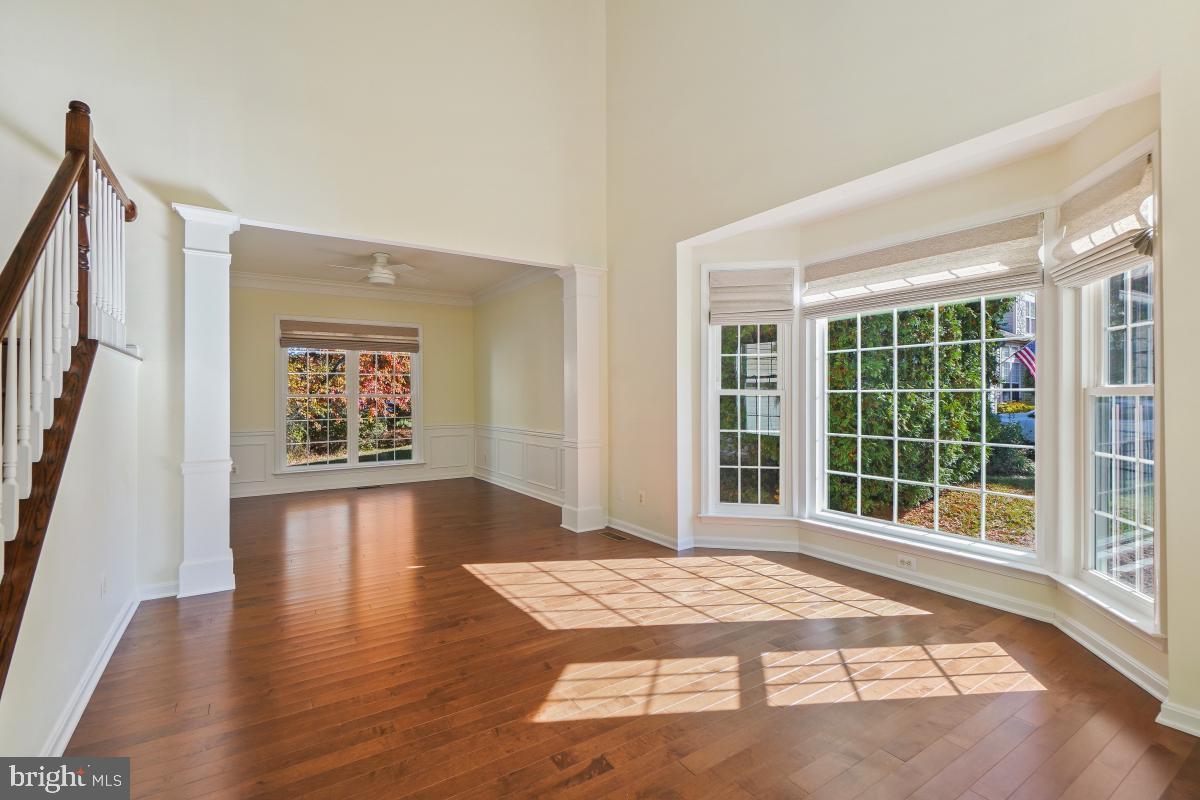 2442 Arctic Fox Way Reston, VA 20191 - Photo 4 of 58 a view of an empty room with wooden floor and a window
