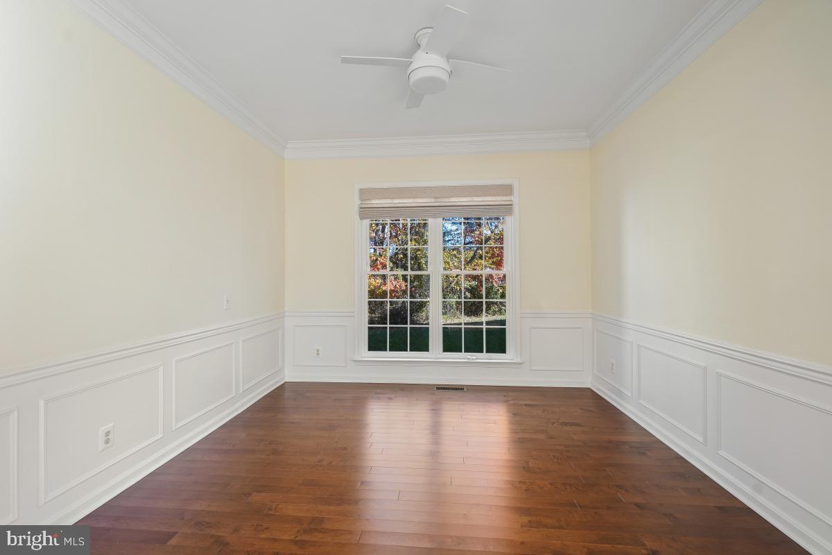 2442 Arctic Fox Way Reston, VA 20191 - Photo 8 of 58 an empty room with wooden floor and windows