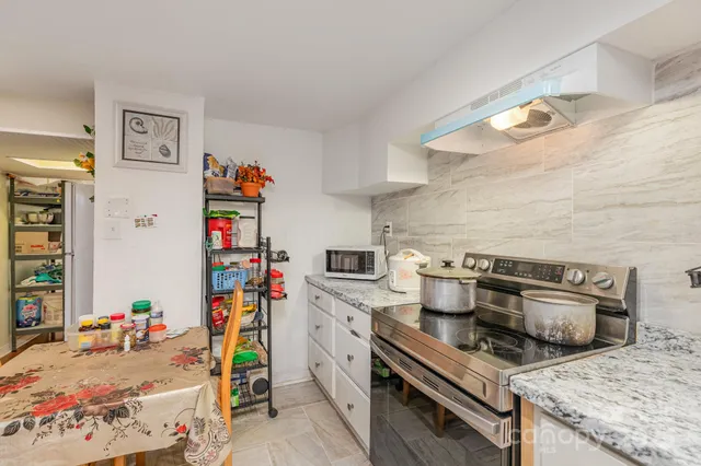 a kitchen with a sink appliances and cabinets