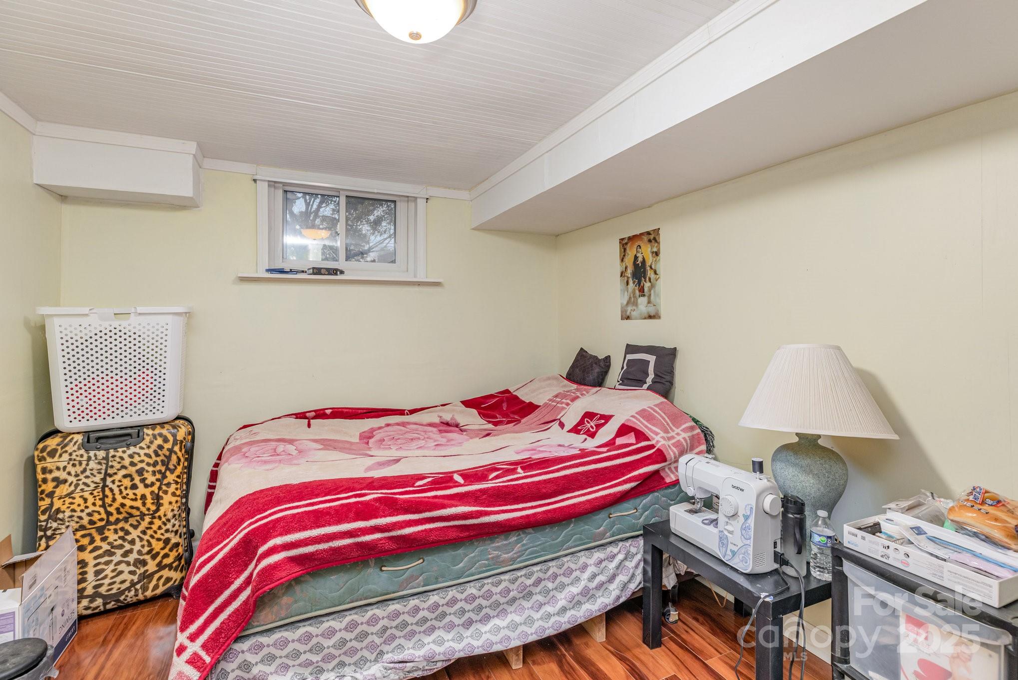 9716 Sunway Drive Mint Hill, NC 28227 - Photo 24 of 31 a bedroom with a bed and wooden floor