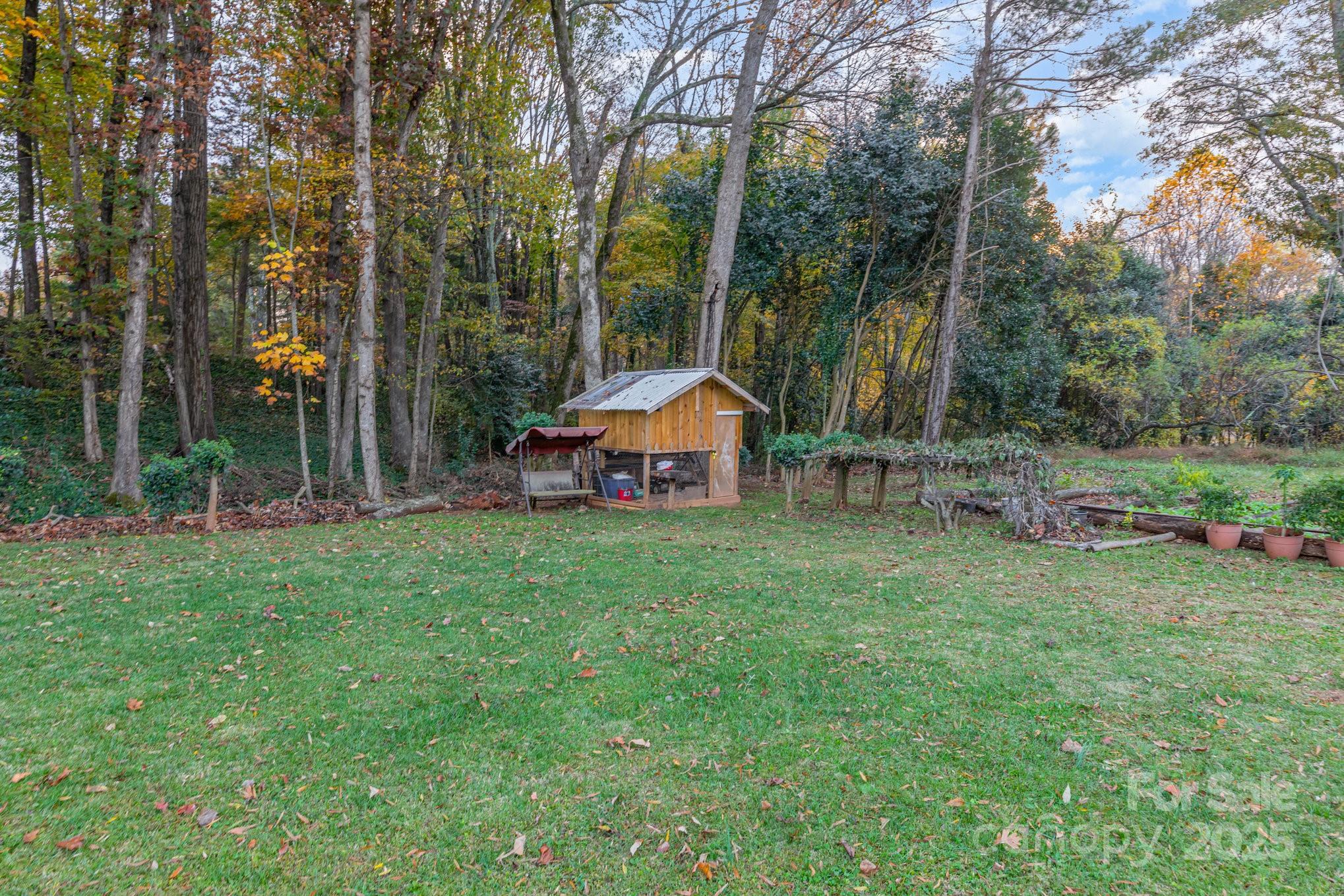 9716 Sunway Drive Mint Hill, NC 28227 - Photo 30 of 31 a backyard of a house with wooden fence and large trees