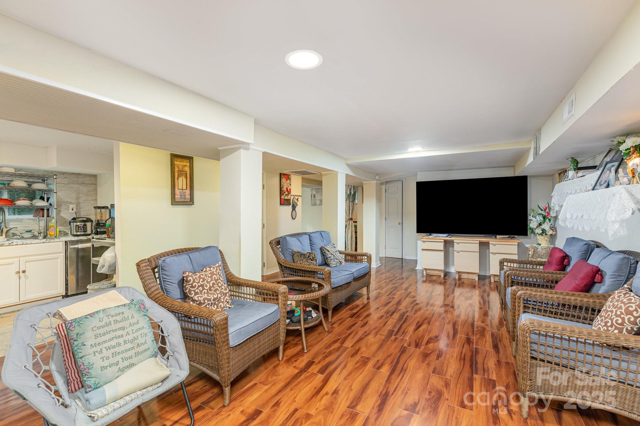 9716 Sunway Drive Mint Hill, NC 28227 - Photo 6 of 31 a living room with furniture and a flat screen tv