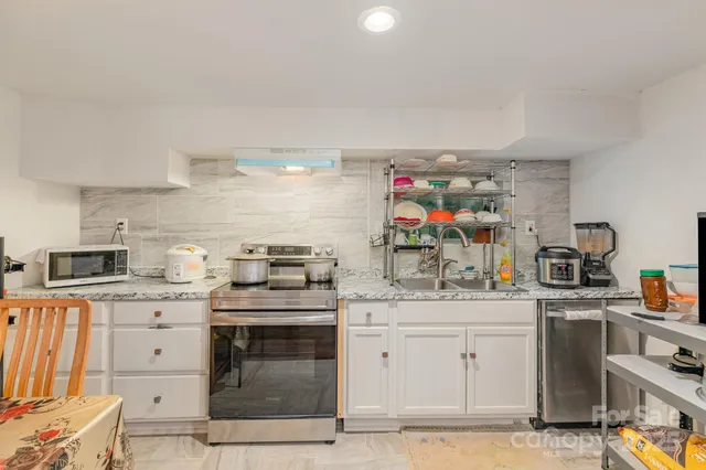 a kitchen with a stove top oven and cabinets