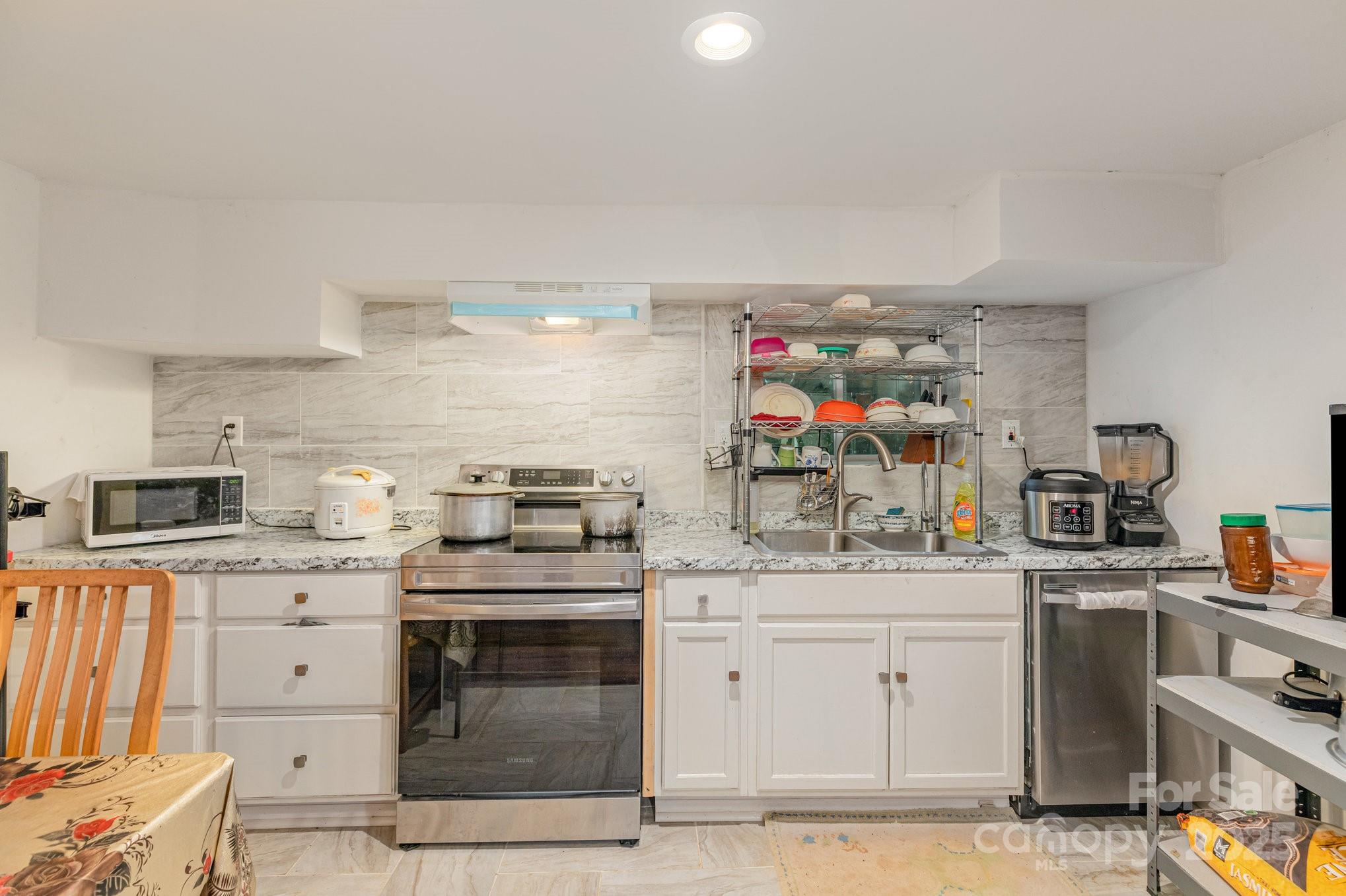 9716 Sunway Drive Mint Hill, NC 28227 - Photo 10 of 31 a kitchen with a stove top oven and cabinets