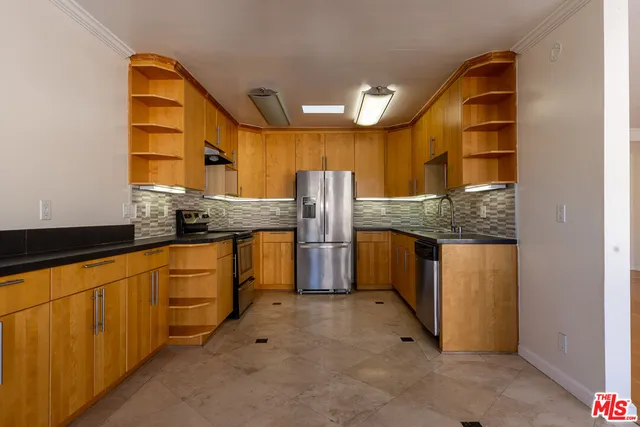 a kitchen with stainless steel appliances granite countertop a sink and cabinets