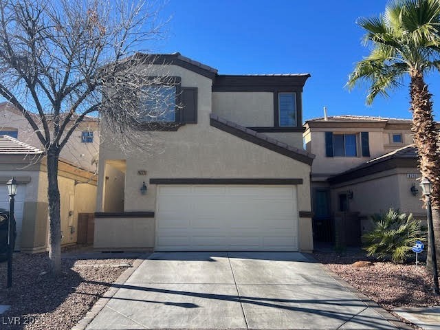Traditional-style house with stucco siding, driveway, and a garage