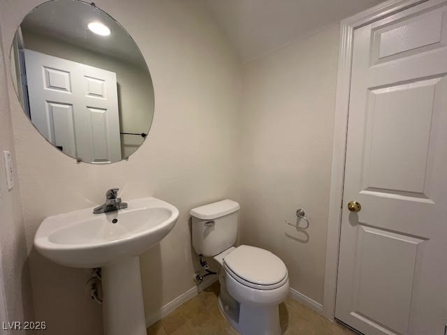 8229 Strawberry Spring Street Las Vegas, NV 89143 - Photo 12 of 40 Half bathroom with vaulted ceiling and light tile patterned floors