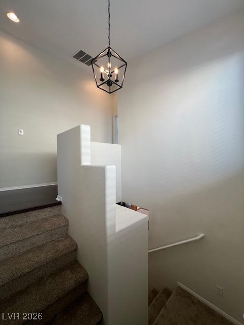 8229 Strawberry Spring Street Las Vegas, NV 89143 - Photo 13 of 40 Staircase featuring baseboards and a chandelier