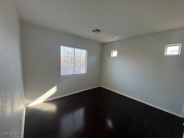 8229 Strawberry Spring Street Las Vegas, NV 89143 - Photo 16 of 40 Spare room featuring dark wood-type flooring and baseboards