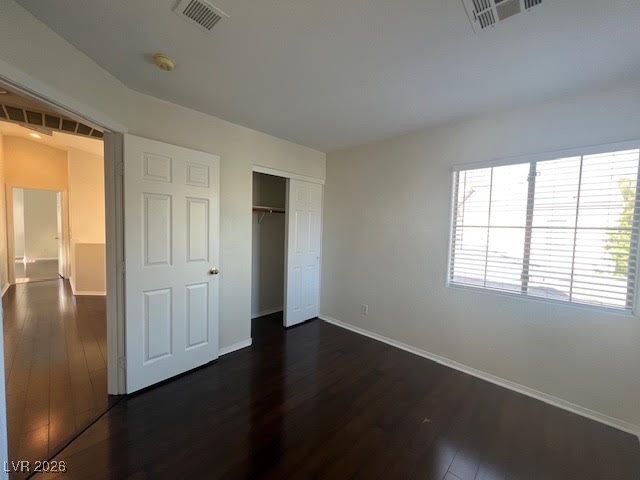8229 Strawberry Spring Street Las Vegas, NV 89143 - Photo 19 of 40 Unfurnished bedroom with dark wood-style floors and a closet