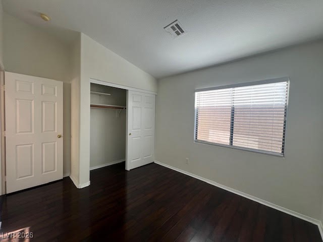 8229 Strawberry Spring Street Las Vegas, NV 89143 - Photo 22 of 40 Unfurnished bedroom with vaulted ceiling, dark wood-type flooring, and a closet