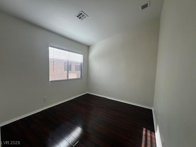 8229 Strawberry Spring Street Las Vegas, NV 89143 - Photo 23 of 40 Empty room with dark wood-style floors and baseboards