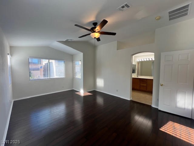 8229 Strawberry Spring Street Las Vegas, NV 89143 - Photo 24 of 40 Unfurnished bedroom with vaulted ceiling, dark wood-type flooring, arched walkways, a ceiling fan, and connected bathroom