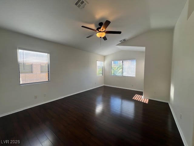 8229 Strawberry Spring Street Las Vegas, NV 89143 - Photo 25 of 40 Empty room featuring vaulted ceiling, dark wood-type flooring, and ceiling fan