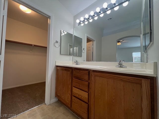8229 Strawberry Spring Street Las Vegas, NV 89143 - Photo 26 of 40 Bathroom featuring double vanity, a spacious closet, light flooring, and ceiling fan