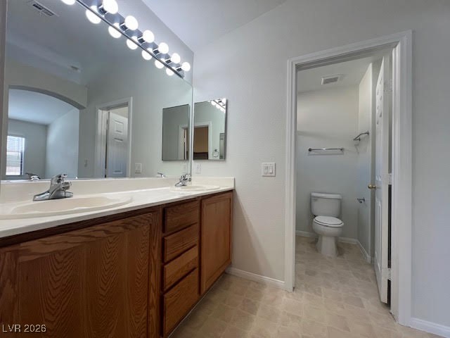 8229 Strawberry Spring Street Las Vegas, NV 89143 - Photo 31 of 40 Bathroom with double vanity and toilet