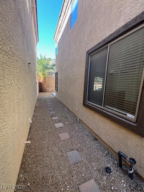8229 Strawberry Spring Street Las Vegas, NV 89143 - Photo 32 of 40 View of property exterior featuring stucco siding