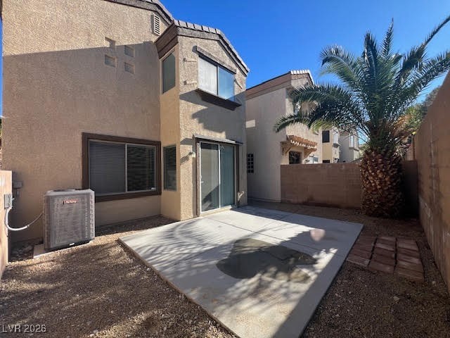 8229 Strawberry Spring Street Las Vegas, NV 89143 - Photo 33 of 40 Back of property with a fenced backyard, stucco siding, and a patio area