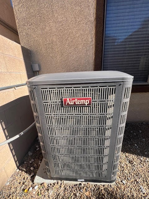 8229 Strawberry Spring Street Las Vegas, NV 89143 - Photo 34 of 40 Exterior view of a central air condition unit and stucco siding