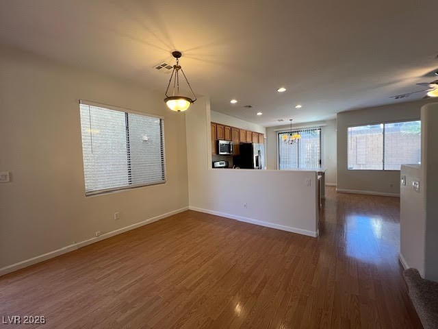8229 Strawberry Spring Street Las Vegas, NV 89143 - Photo 6 of 40 Unfurnished living room with recessed lighting, dark wood-style floors, a chandelier, and a ceiling fan