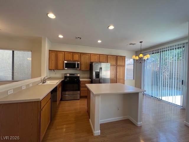 8229 Strawberry Spring Street Las Vegas, NV 89143 - Photo 7 of 40 Kitchen with brown cabinets, appliances with stainless steel finishes, hanging light fixtures, healthy amount of natural light, and recessed lighting