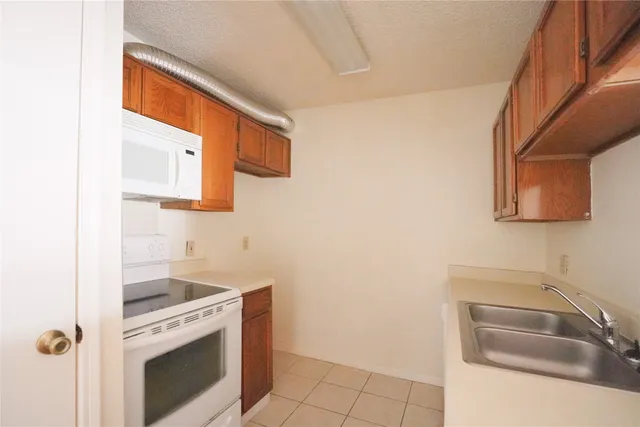 a kitchen with a sink cabinets and a wooden floor