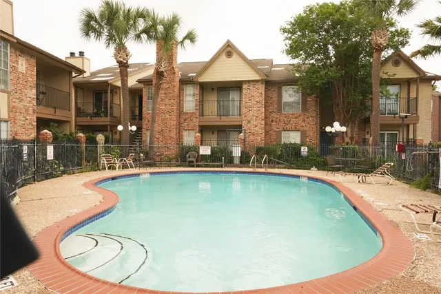 a view of a house with swimming pool and porch