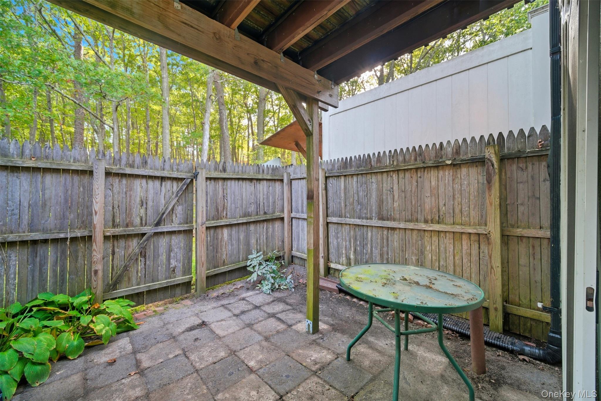 24 Wooded Way Calverton, NY 11933 - Photo 13 of 29 a view of a backyard with a small pool and a wooden bench in the back