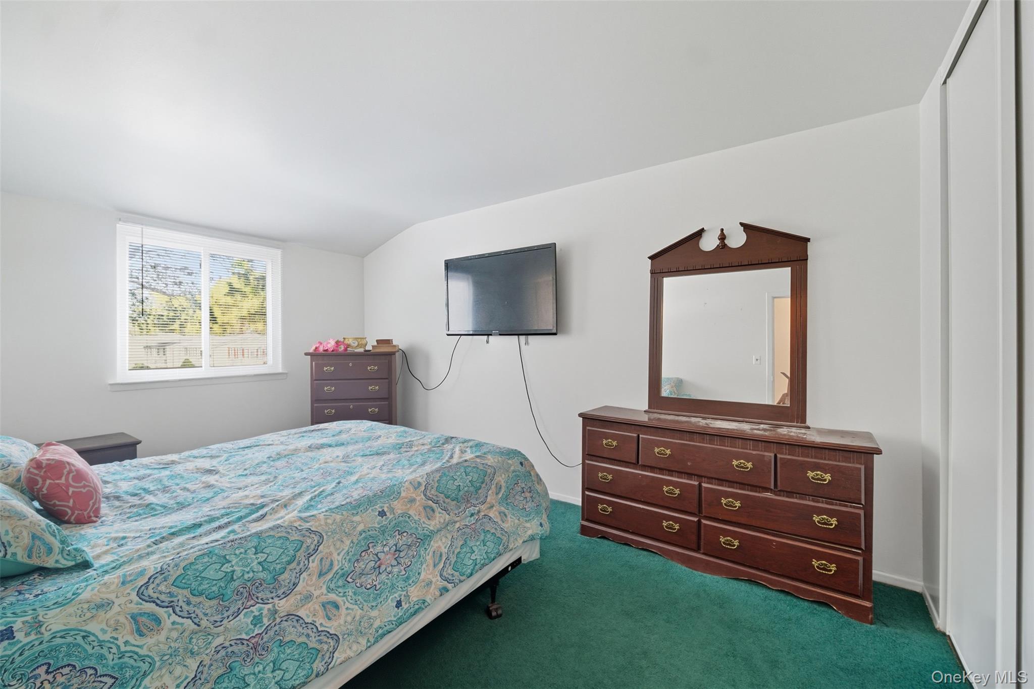 24 Wooded Way Calverton, NY 11933 - Photo 14 of 29 a bedroom with a bed and a flat screen tv