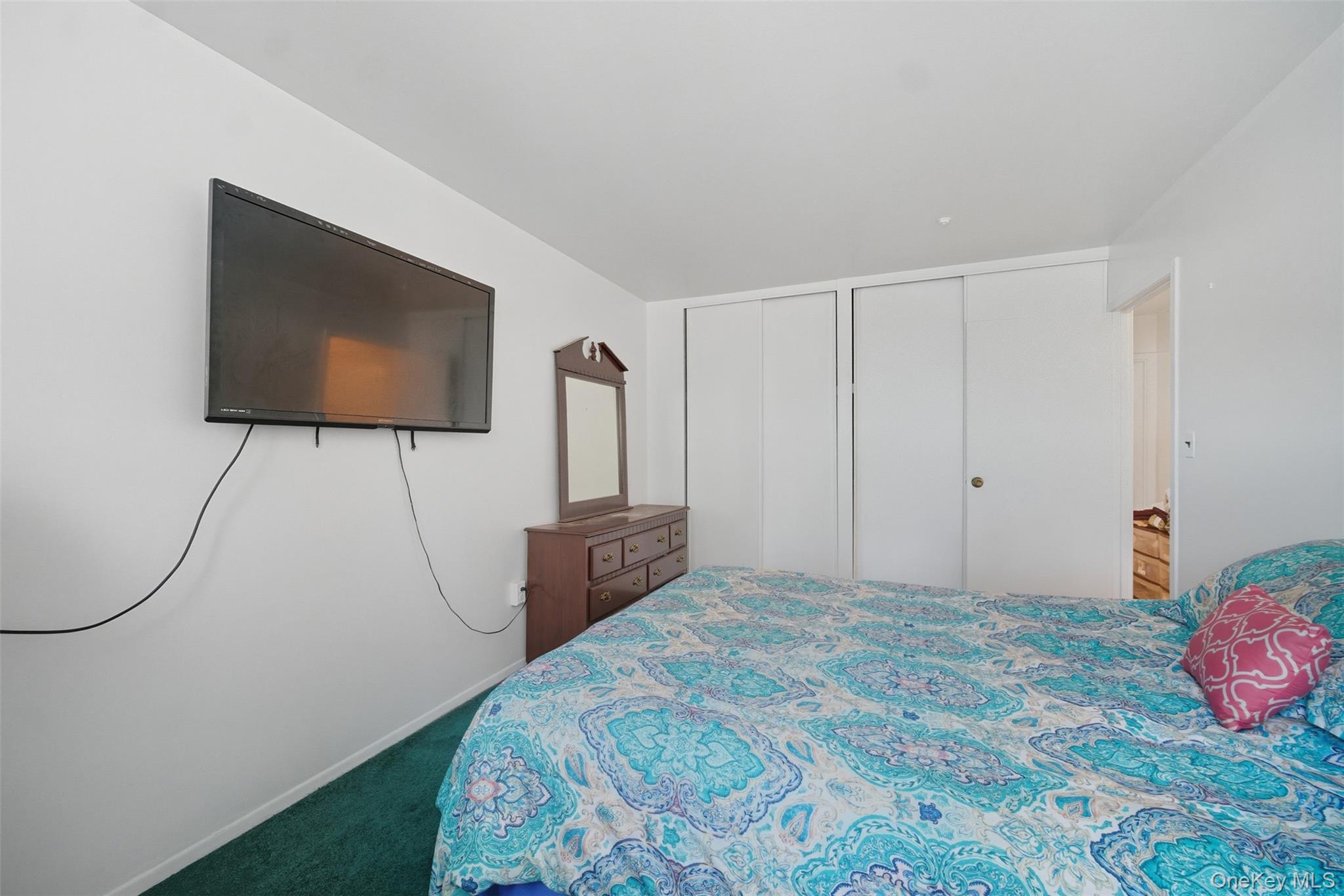 24 Wooded Way Calverton, NY 11933 - Photo 15 of 29 a bedroom with a bed and a flat screen tv