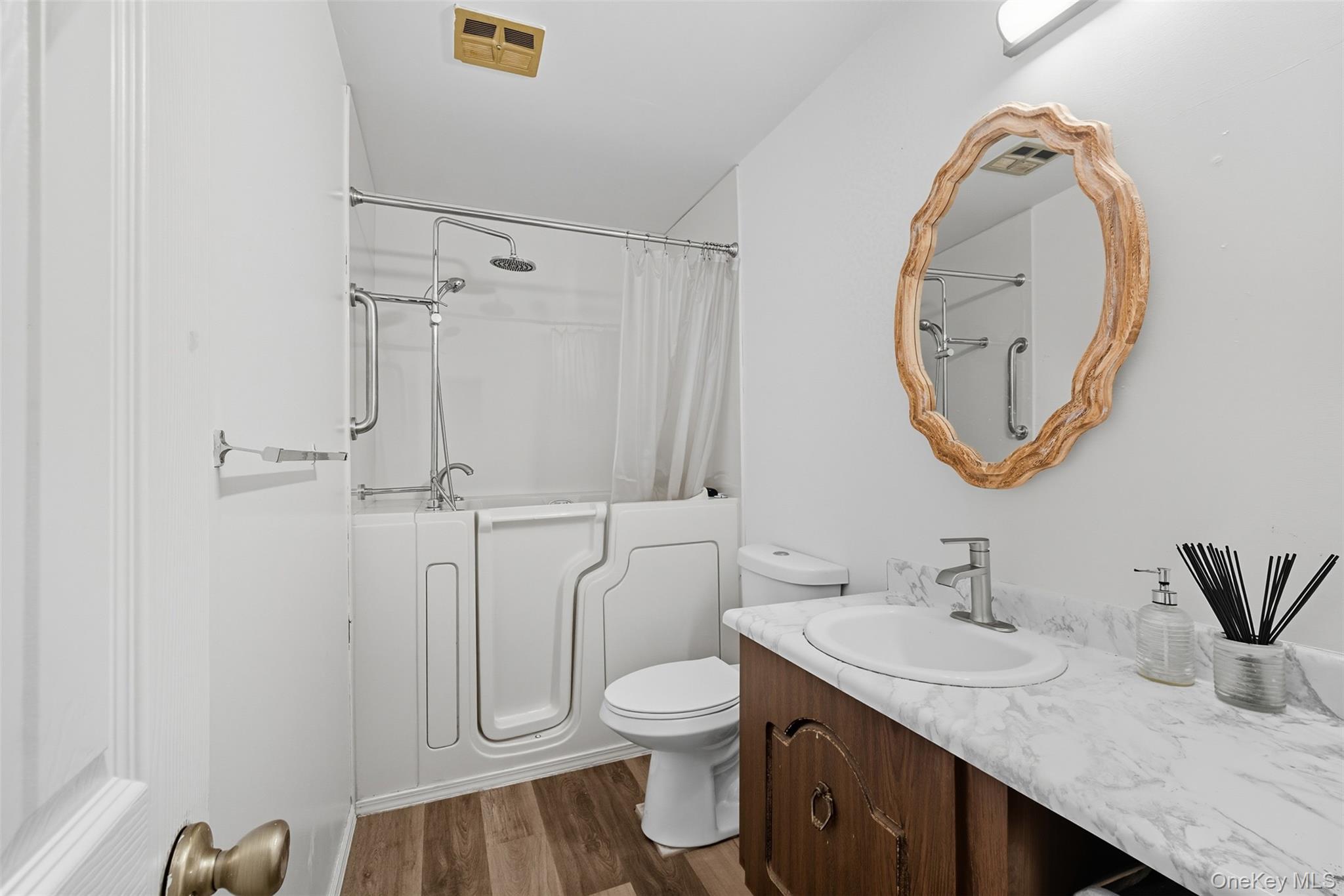 24 Wooded Way Calverton, NY 11933 - Photo 18 of 29 a bathroom with a granite countertop toilet sink and mirror