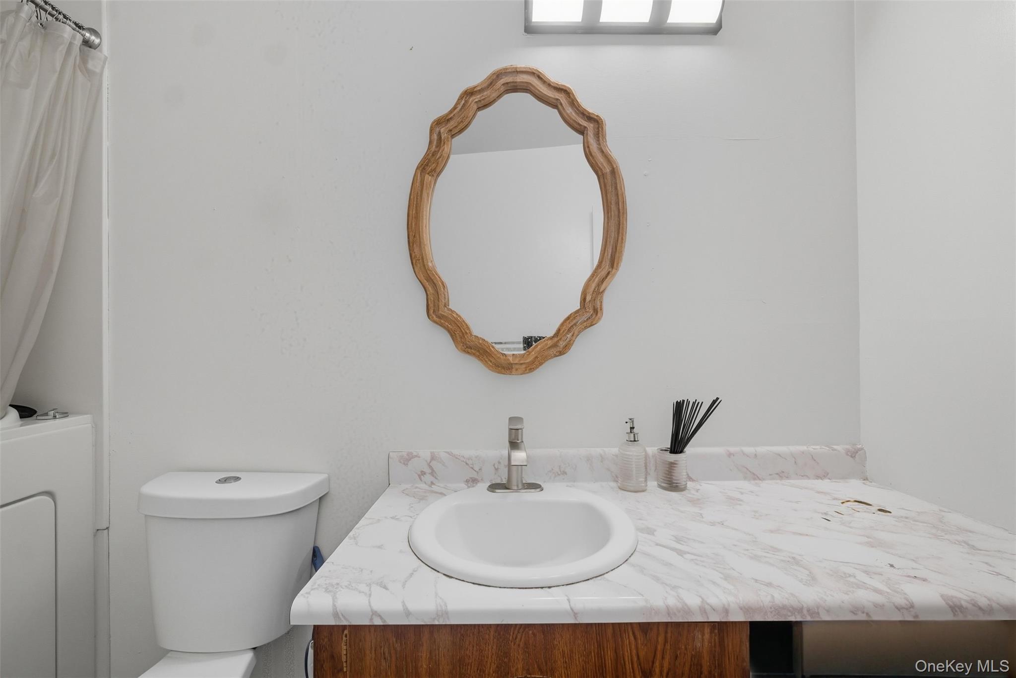 24 Wooded Way Calverton, NY 11933 - Photo 19 of 29 a bathroom with a granite countertop sink and a mirror