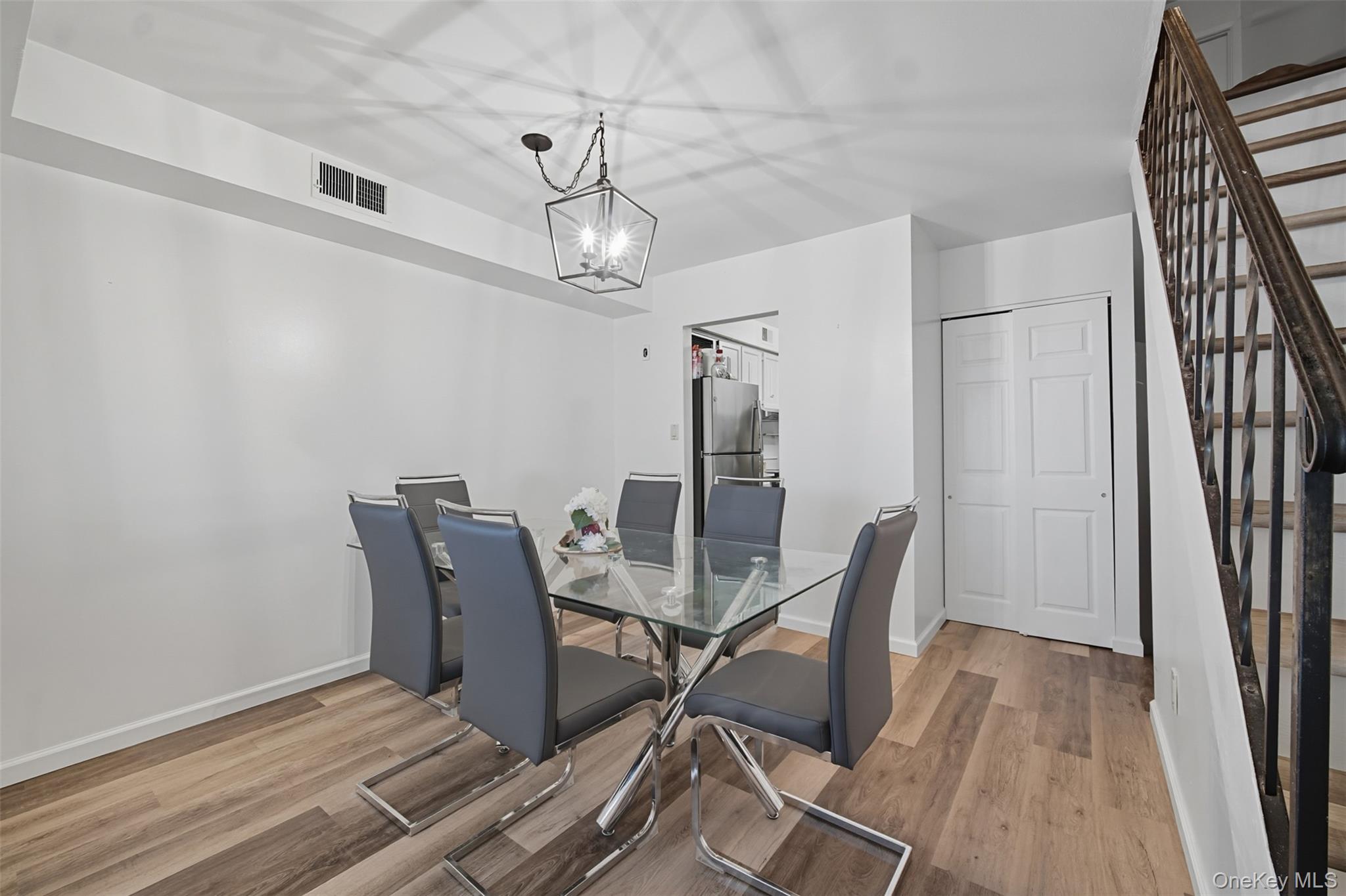 24 Wooded Way Calverton, NY 11933 - Photo 2 of 29 a view of a dining room with furniture and wooden floor