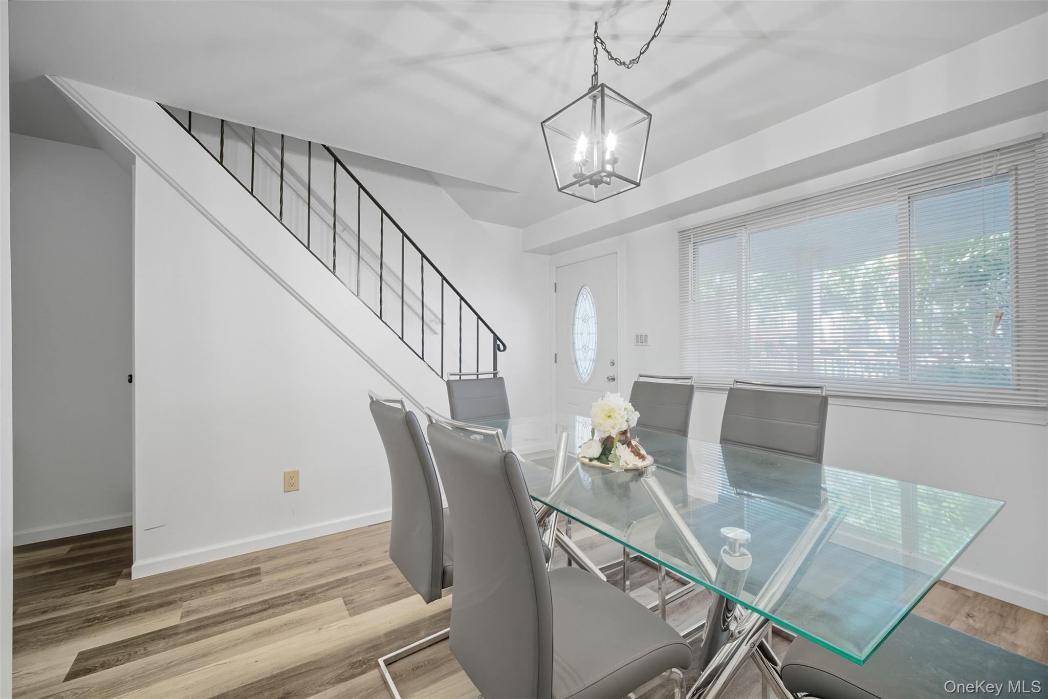 24 Wooded Way Calverton, NY 11933 - Photo 5 of 29 a view of a dining room with furniture window and wooden floor