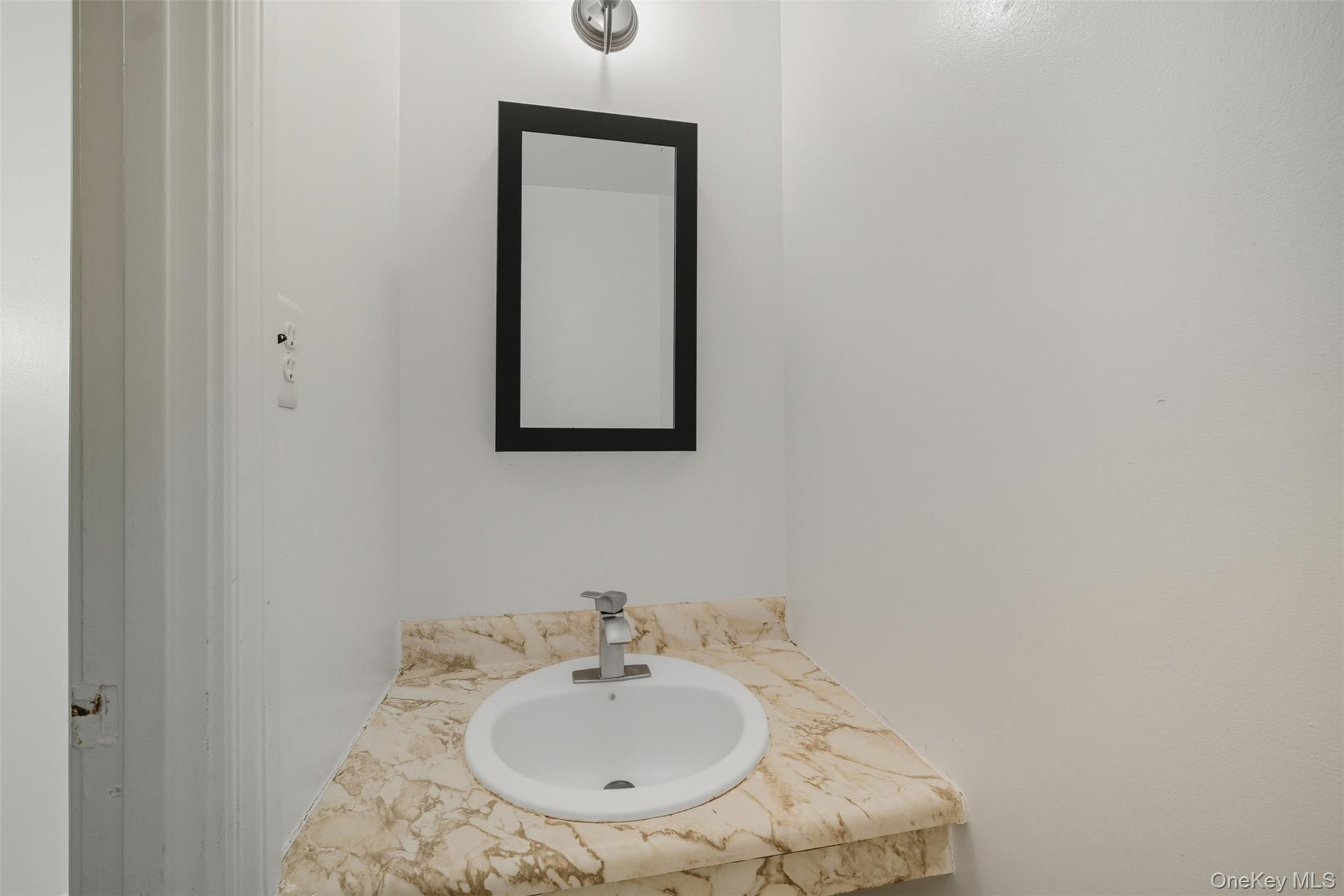 24 Wooded Way Calverton, NY 11933 - Photo 8 of 29 a bathroom with a sink and a mirror