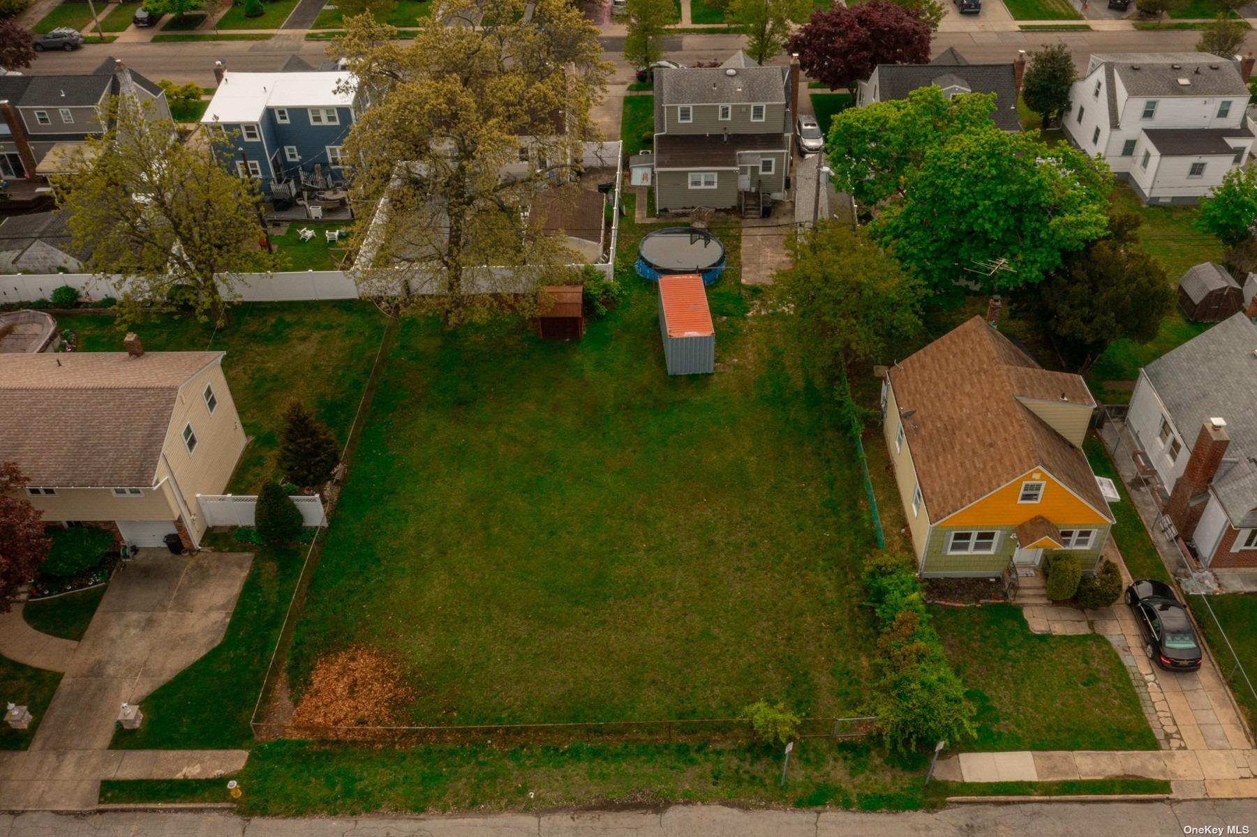 an aerial view of multiple houses with yard