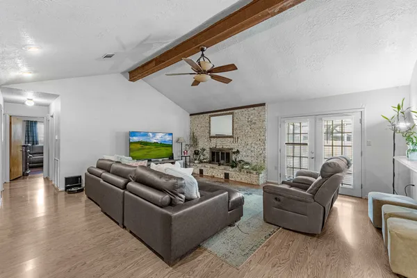 a living room with furniture ceiling fan and a rug