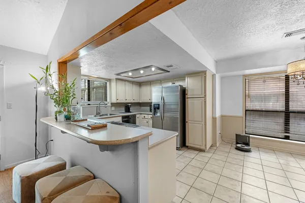 a kitchen with a sink refrigerator and cabinets