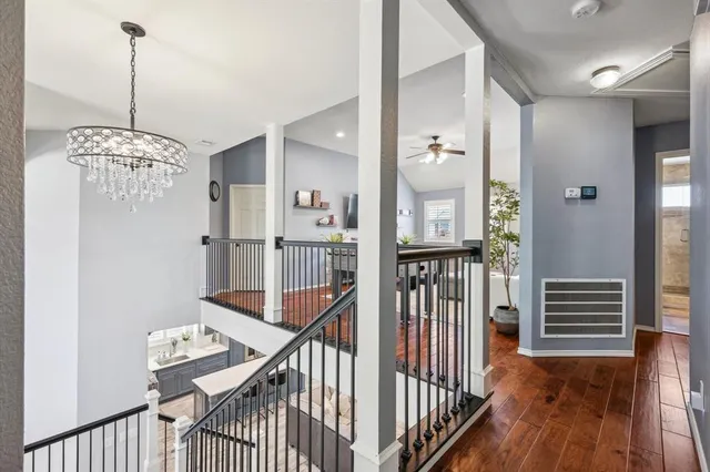 a view of a hallway view with wooden floor and staircase