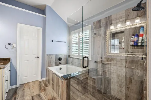a bathroom with a sink a mirror and a shower